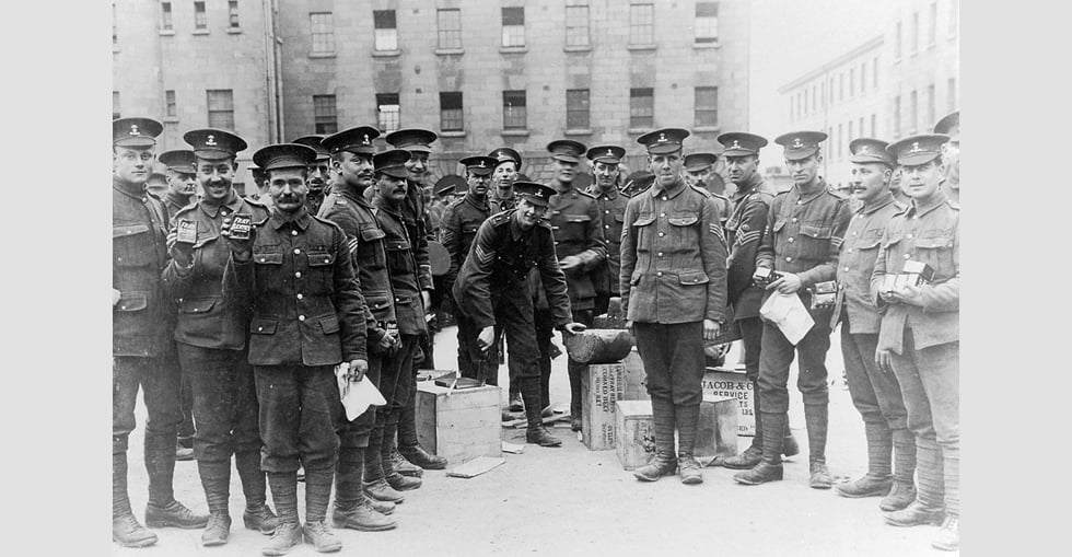 A group of soldiers stand with their food supply for the journey to Basingstoke.