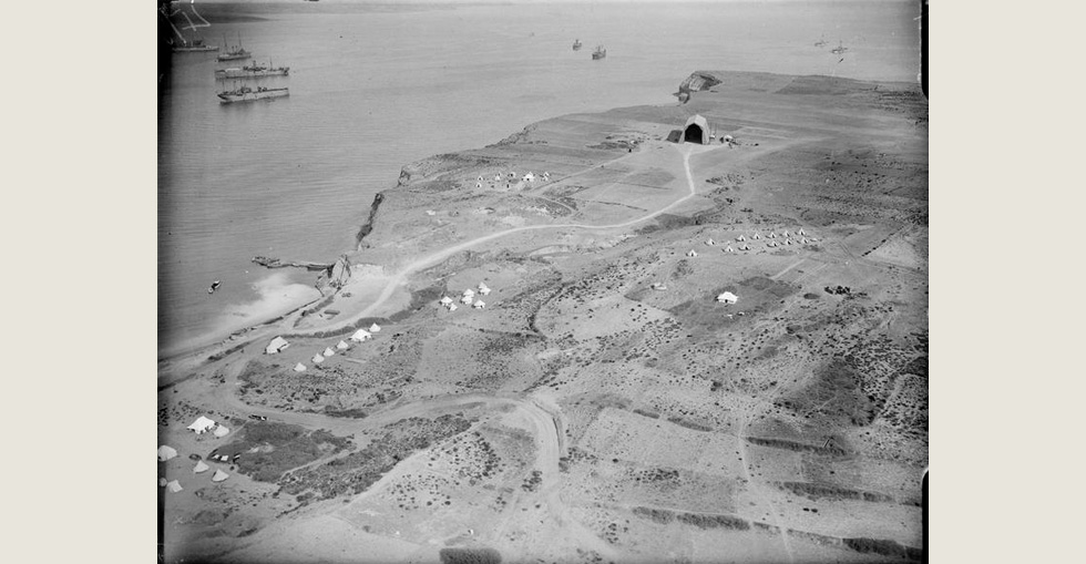 Aerial view of a location in the Dardanelles, showing camps and warships in the harbour, 29 March 1915