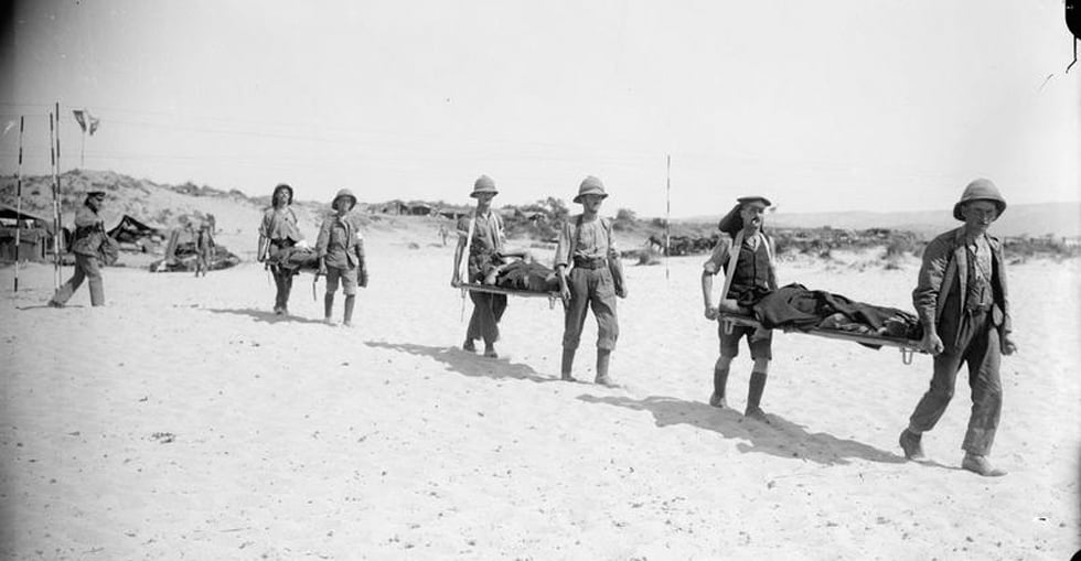 Carrying the wounded on stretchers from hospital to the jetty for transshipment to the Hospital Ship.