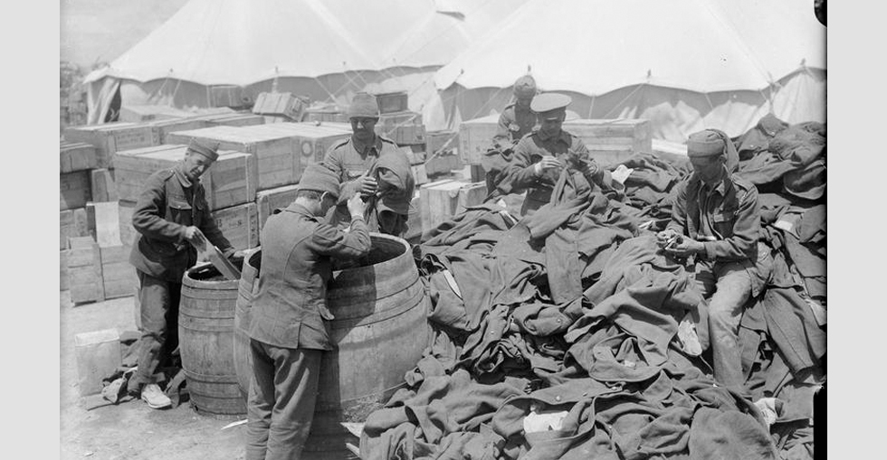 Men of the Army Ordnance Corps disinfecting clothing in improvised disinfectors, known as Serbian barrels.