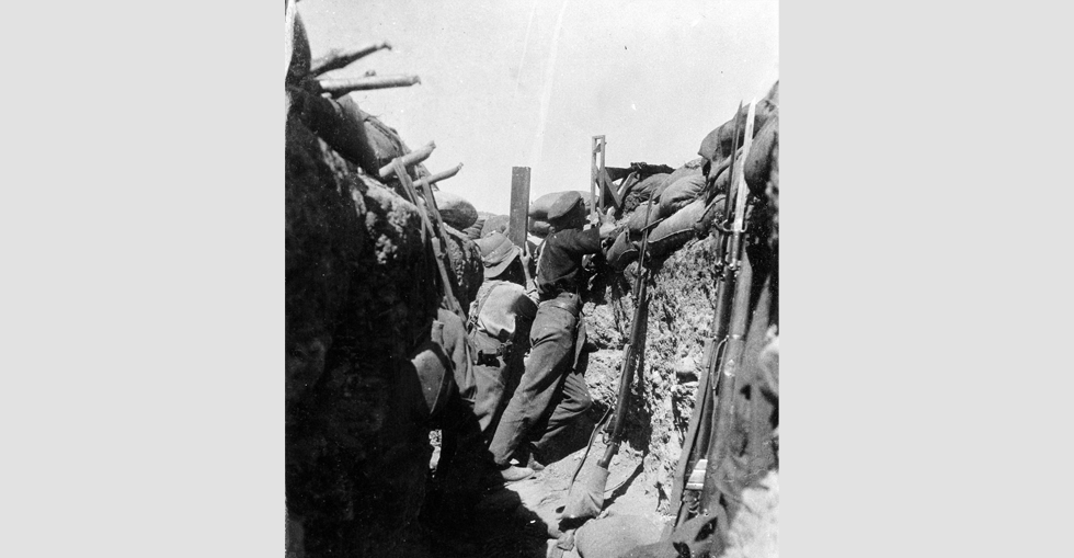 Soldiers in a trench using a periscope rifle