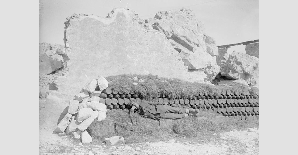 A shell dump in the ruins of the old fort at Sedd-el Bahr, Cape Helles, screened from aerial observation by cut grass.