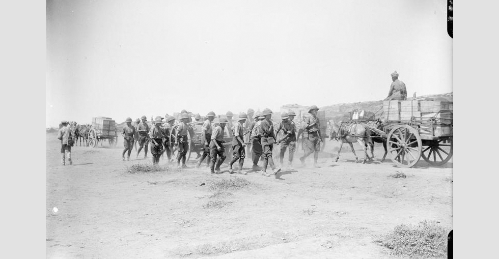 Troops hauling a water cart and Indian ammunition transport carts with stores at Suvla Bay.