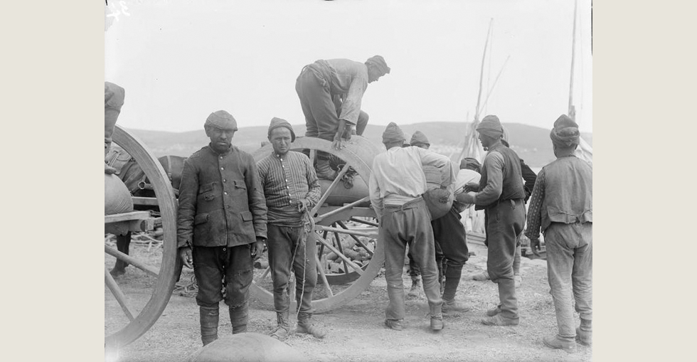 Turkish prisoners, captured during the Gallipoli campaign, loading a cart in the French Sector of V Beach at Sedd el Bahr, Cape Helles.