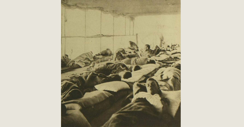 Wounded soldiers on the deck of a temporary hospital carrier ship