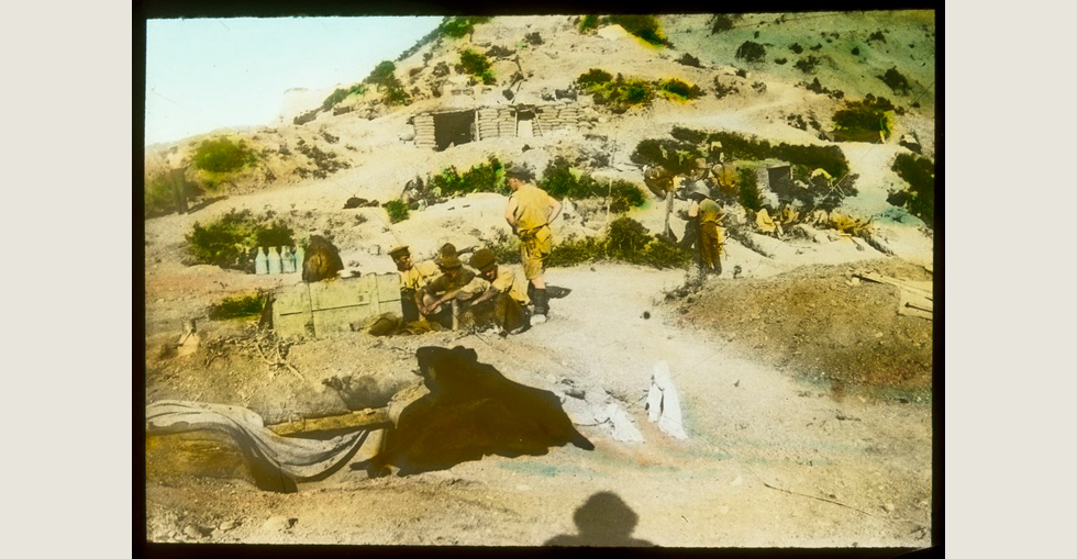 Australian army camp at Gallipoli. Group of soldiers sitting near a supply box as another stands by them.